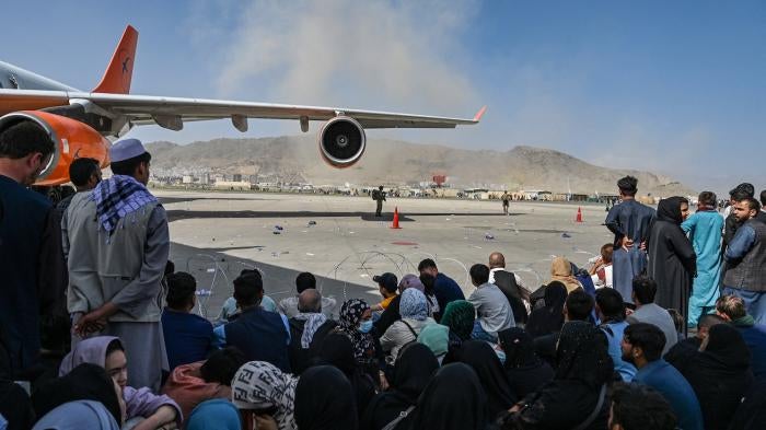 Afghans waiting to leave Afghanistan from Kabul’s international airport after the Taliban takeover, August 16, 2021.