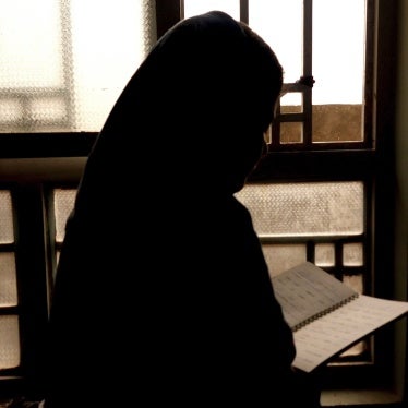 A 15-year-old girl, barred from attending secondary school since 2021, reads a notebook in Afghanistan, March 20, 2024.